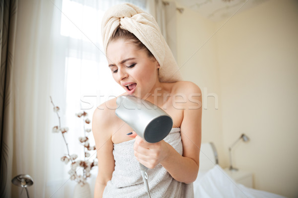 Charming woman singing in hairdrye Stock photo © deandrobot