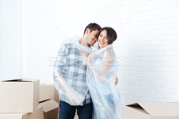 Young pretty couple moving in new flat Stock photo © deandrobot