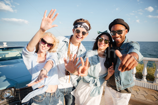 Multiethnic group of cheerful young people standing on promenade Stock photo © deandrobot