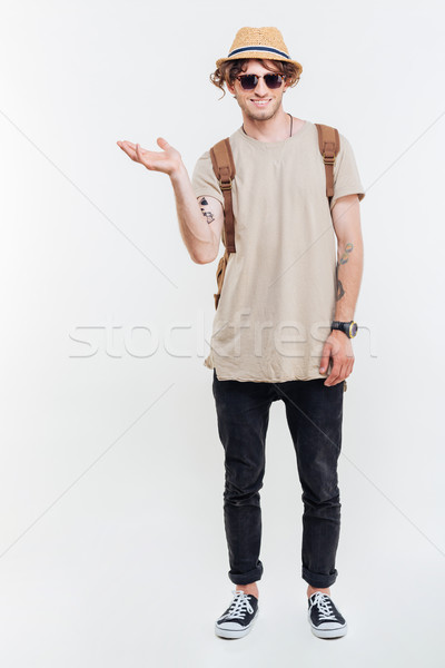 Full length portrait of a smiling man holding invisible product Stock photo © deandrobot