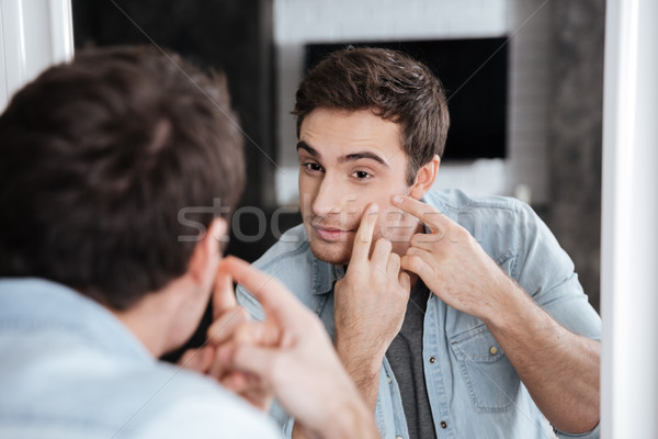 Man in the bathroom Stock photo © deandrobot