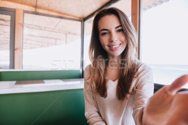 Woman on date in cafe touching her man Stock photo © deandrobot