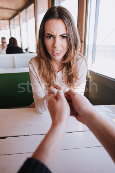 Vertical image of woman pulls out credit card Stock photo © deandrobot