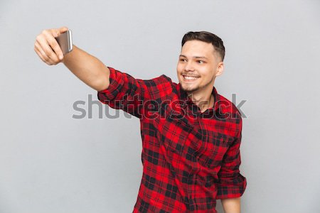 Funny man in shirt making selfie Stock photo © deandrobot