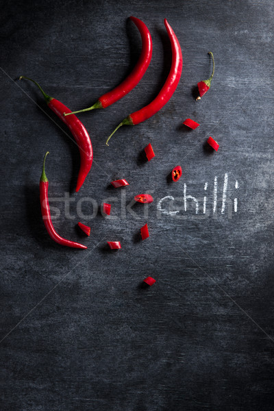 ?ut chilli pepper over dark background. Stock photo © deandrobot