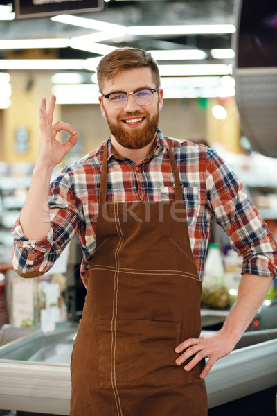 Wesoły kasjer człowiek supermarket sklep Zdjęcia stock © deandrobot