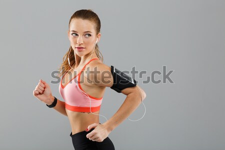 Concentrated young sports woman make exercises Stock photo © deandrobot