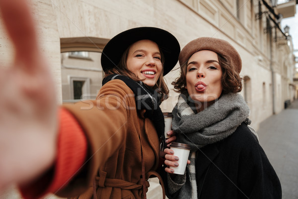 Portrait of two cheerful girls dressed in autumn clothes Stock photo © deandrobot