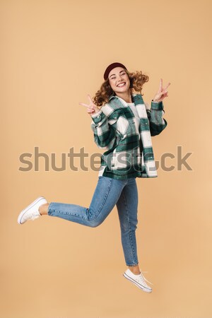 Full length image of smiling ginger woman in shirt Stock photo © deandrobot