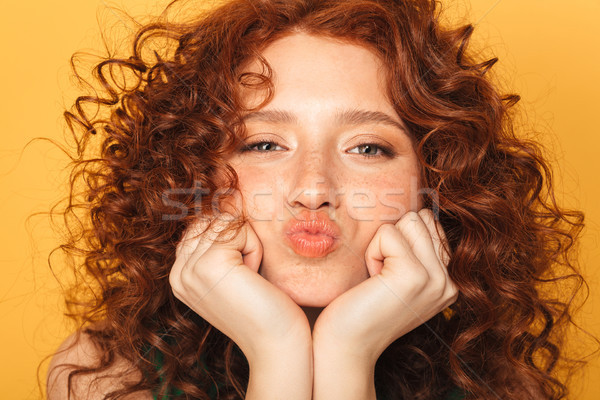 Close up portrait of a lovely curly redhead woman Stock photo © deandrobot
