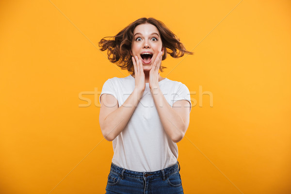 Shocked young woman looking camera. Stock photo © deandrobot