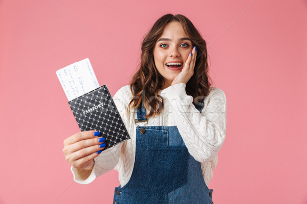 Portrait of a cheerful young girl showing passport Stock photo © deandrobot