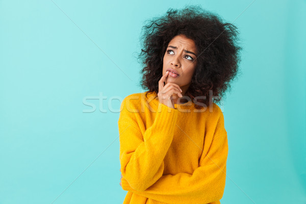 American woman in colorful shirt looking upward remembering or r Stock photo © deandrobot