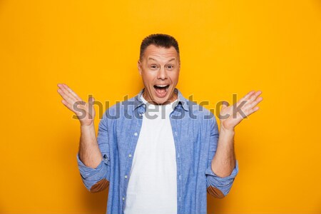 Portré boldog középkorú férfi mutat ujjak felfelé Stock fotó © deandrobot