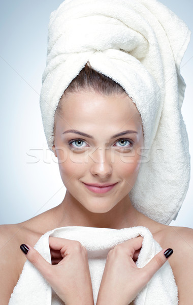 Closeup portrait of a happy woman with perfect skin and towel on head Stock photo © deandrobot