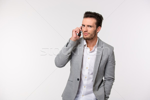 Handsome businessman talking on the phone Stock photo © deandrobot