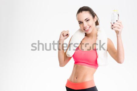 Excited happy sportswoman with white towel  Stock photo © deandrobot