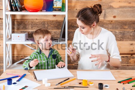 Concentrated mother and little son drawing in art school Stock photo © deandrobot
