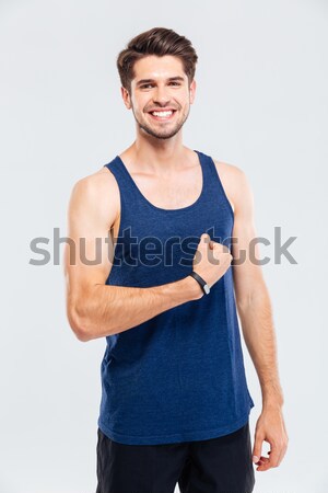 Közelkép portré mosolyog férfi mutat bicepsz Stock fotó © deandrobot