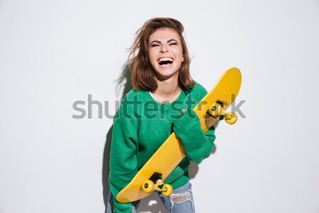 Zâmbitor patinator doamnă skateboard fotografie verde Imagine de stoc © deandrobot