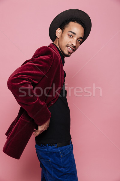 Stylish handsome afro american in hat and jacket posing Stock photo © deandrobot