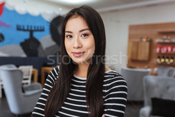 Pretty Asian woman in cafeteria Stock photo © deandrobot