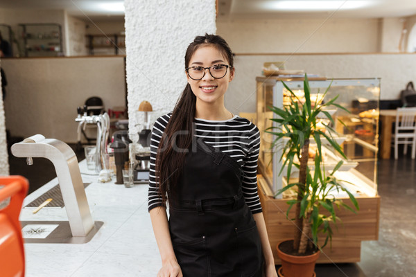 Asian barmaid in eyeglasses Stock photo © deandrobot