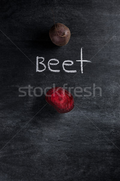Cut beet over dark chalkboard background Stock photo © deandrobot