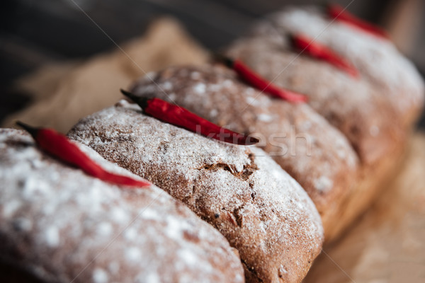Bread with flour and pepper on dark wooden table Stock photo © deandrobot