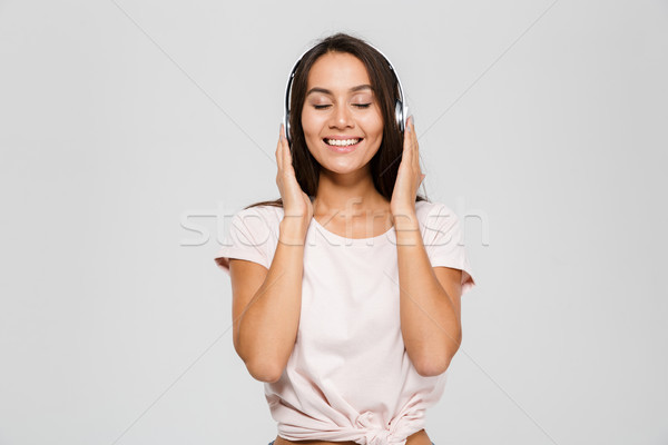 Portrait heureux satisfait asian femme casque [[stock_photo]] © deandrobot