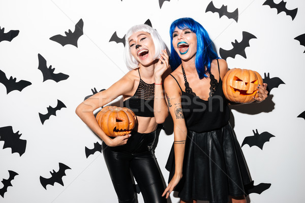 Emocjonalny młodych kobiet halloween kostiumy zdjęcie dwa Zdjęcia stock © deandrobot