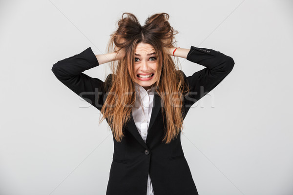 Portrait of a confused businesswoman dressed in suit Stock photo © deandrobot