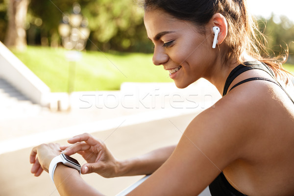 Close up of a happy fitness woman leaning on a rail Stock photo © deandrobot