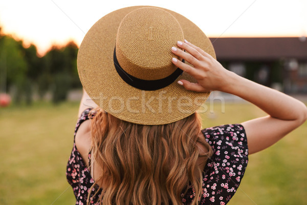 Portrait from back of european woman 20s wearing straw hat and d Stock photo © deandrobot