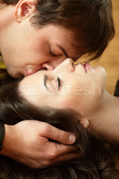 Young man kisses his beautiful girlfriend Stock photo © deandrobot