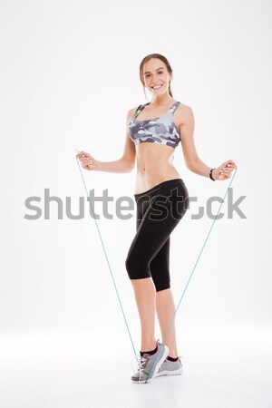 Stock photo: Cheerful winking young woman in black swimwear with hamburger print 