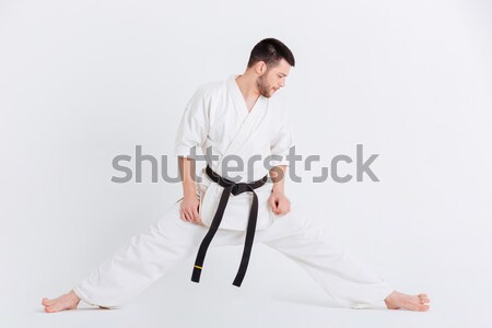 Man in kimono doing stretching exercises Stock photo © deandrobot