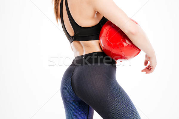 Cropped image of a sexy women body holding red ball Stock photo © deandrobot