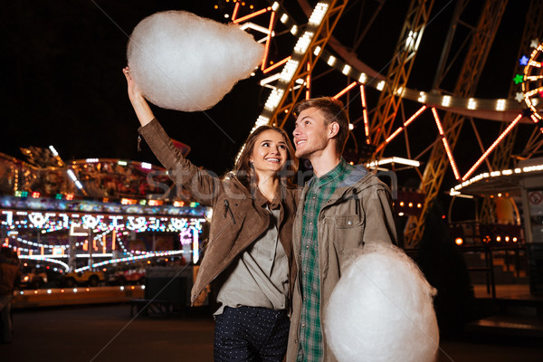 Couple in amusement park eating cotton candy Stock photo © deandrobot