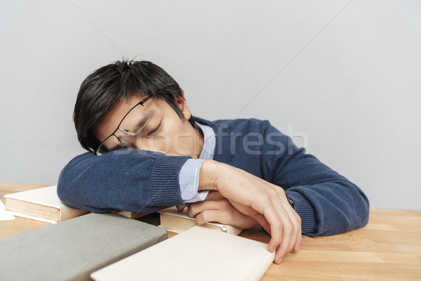 Asian man asleep on the table Stock photo © deandrobot