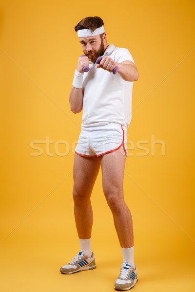 Vertical image of sportsman beats at camera Stock photo © deandrobot