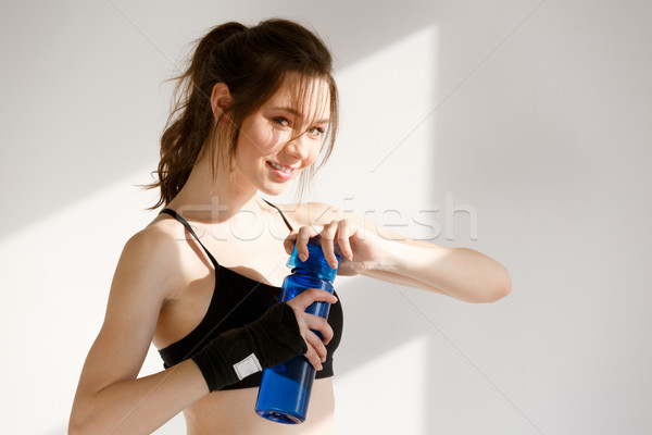 Smiling young sports woman boxer Stock photo © deandrobot