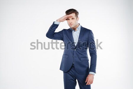 Man in suit peers away Stock photo © deandrobot