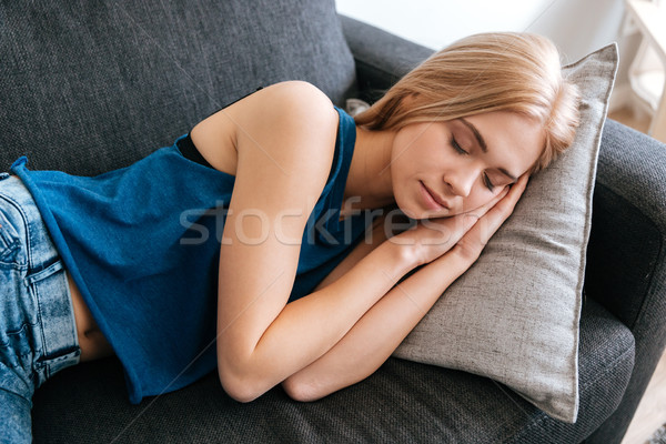 Tired fatigued young woman sleeping at home Stock photo © deandrobot