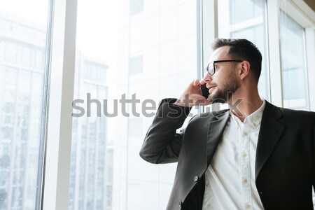 Feliz barbudo homem de negócios falante telefone Foto stock © deandrobot