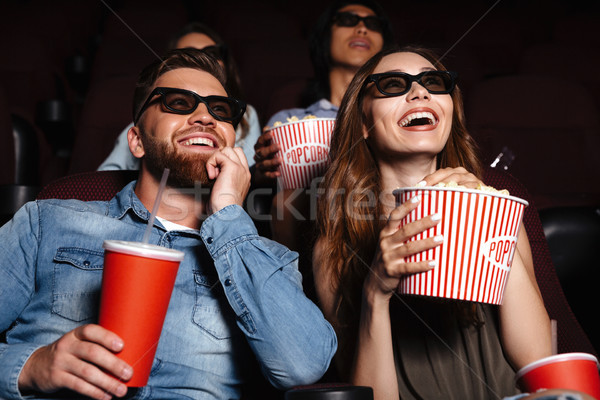 Happy friends sitting in cinema watch film Stock photo © deandrobot