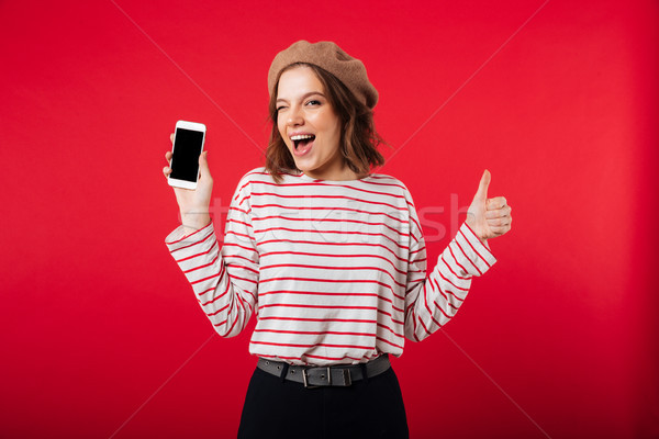 Portrait of a cheerful woman wearing beret Stock photo © deandrobot