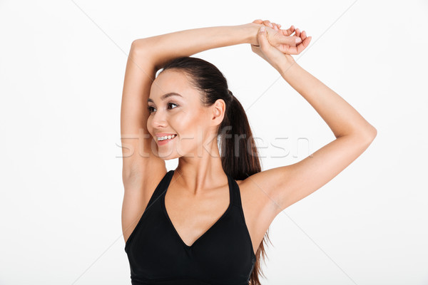 Close up portrait of a fitness woman stretching her hands Stock photo © deandrobot