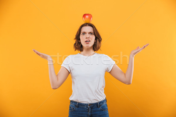 Confused displeased young woman standing isolated Stock photo © deandrobot