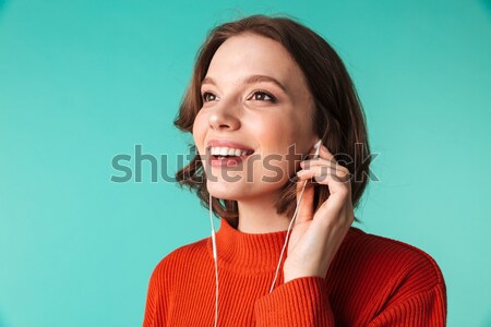 Portrait of a cute young woman dressed in sweater Stock photo © deandrobot